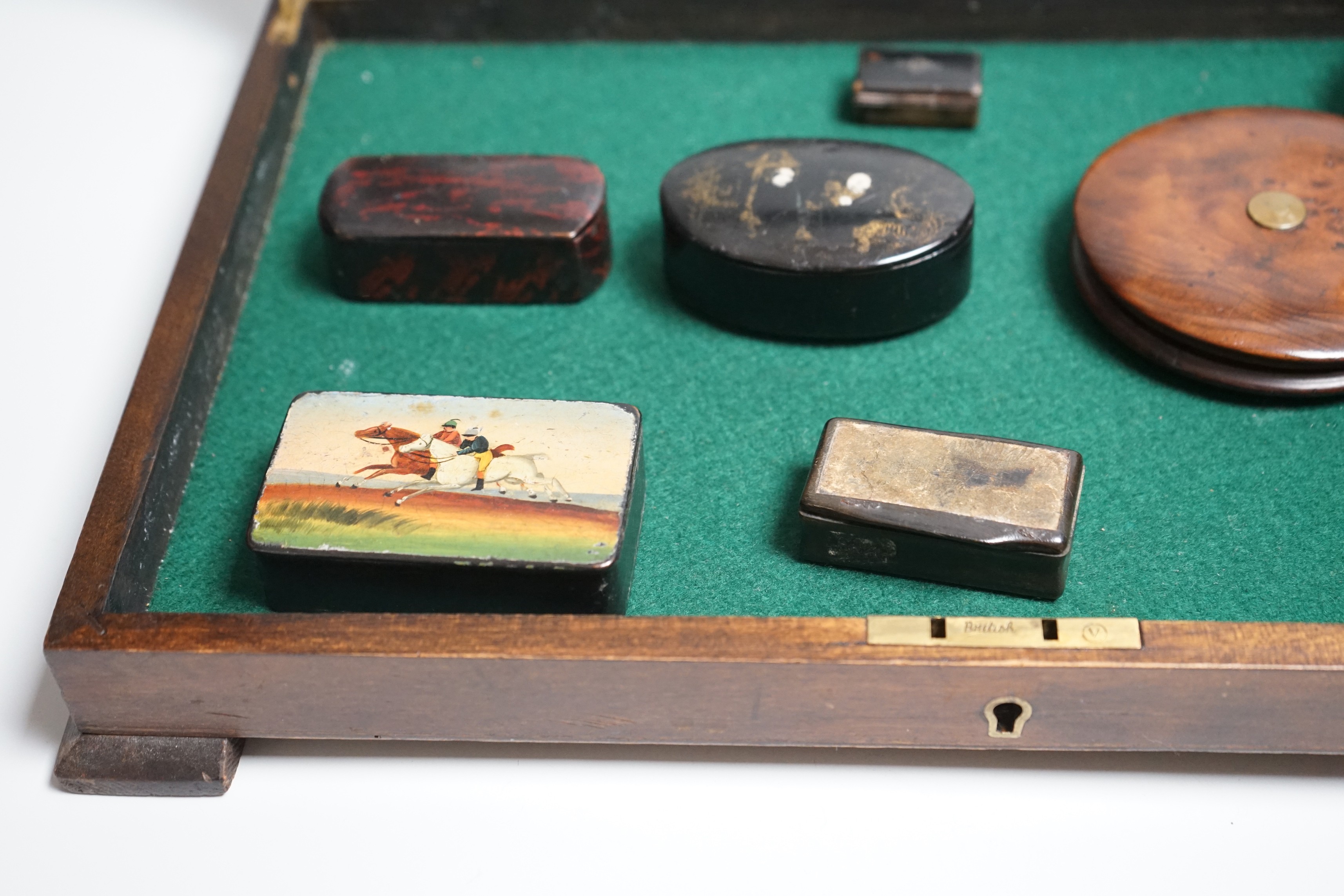 A collection of turned treen and various japanned papier mache boxes, contained in a glazed topped mahogany box-37cms x 24cms